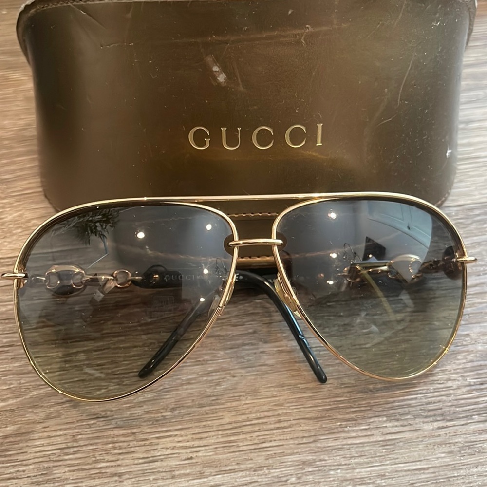 Gucci sunglasses used translucent black lens with gold
